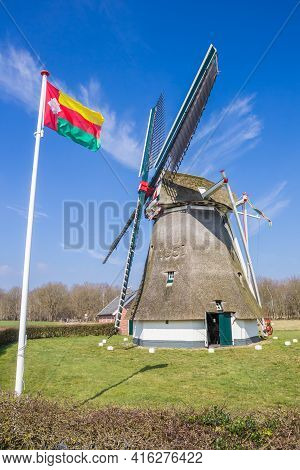 Tynaarlo Flag In Front Of The Historic Windmill In Oudemolen, Netherlands