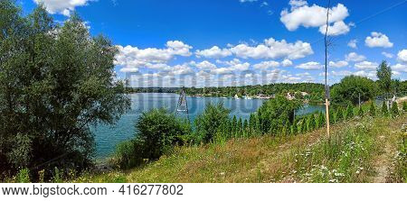 Wide Angle Panorama Shot Of A Man Made Lake Lagoon Named Kryspinow Against Dramatic Clouds Located I