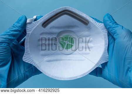 Gloved Hands Holding A Mask With A Filter, White Filter Mask Ffp1, Ppe
