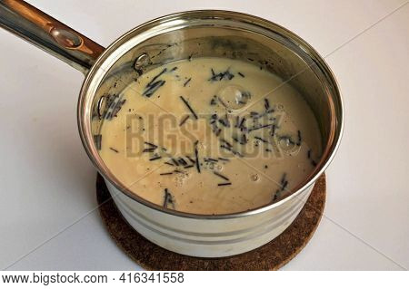 Pour The Warmed Milk Into A Container.