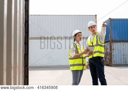 Asian Men And Women Freight  Supervisor Wearing Safety Vest And Hat While Inspect Condition Of All C