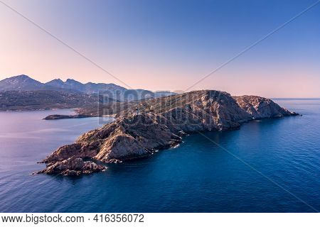 Aerial View Of Revellata Lighthouse In The Evening Sun On A Rocky Promontory Near Calvi In The Balag