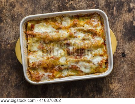 Fresh Cannelloni Pasta With Spinach And Ricotta Baked With Mozzarella Cheese In A Baking Dish On A W