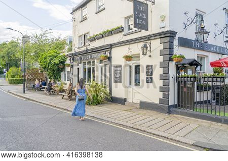 July 2020. London. People Walking Past The Black Lion Pub, Hammersmith, London, England