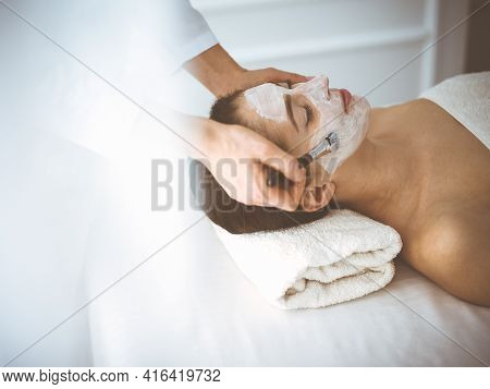 Beautiful Brunette Woman Enjoying Applying Cosmetic Mask With Closed Eyes Comfortable And Blissful. 