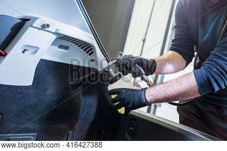A Car Service Worker Cleans Interiror With A Special Foam Generator