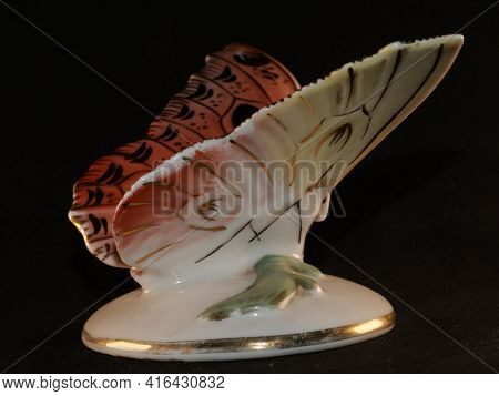 Porcelain Butterfly Figurine Isolated On Black Background