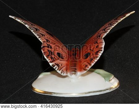 Porcelain Butterfly Figurine Isolated On Black Background
