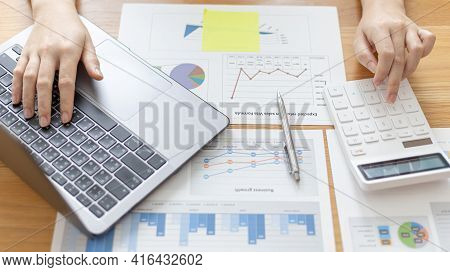 Financial Businesswomen Use Laptop To Analyze Marketing Strategies And Real Estate Data To Reduce Co
