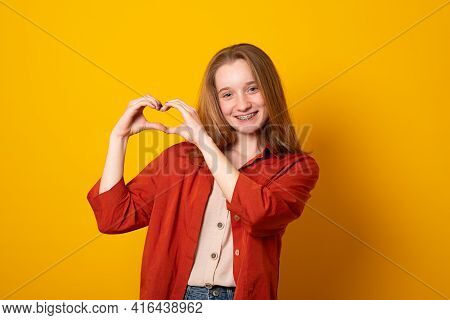 Be My Valnetine. Cute Young Girl Confesses In Love, Shows Heart Gesture, Smiles Broadly, Has Romanti