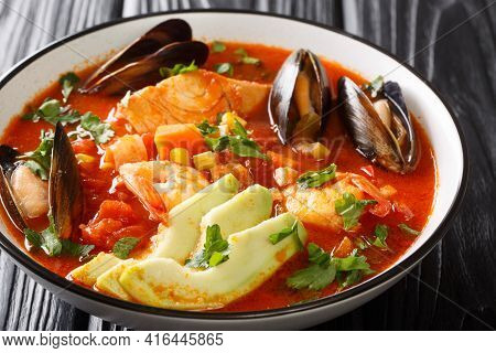 Delicious Soup With Seafood, Corn, Celery, Tomatoes, Carrots And Avocado Close-up In A Bowl On The T