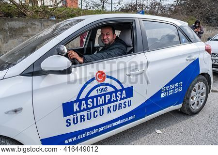 Kemerburgaz, Istanbul, Turkey - 03.19.2021: Middle Aged Male Instructor Of Driving Test Car Sitting 