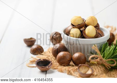 Dry Roasted Macadamia Nut In White Cup On White Wood Background,macadamia Nuts Are Loaded With Flavo