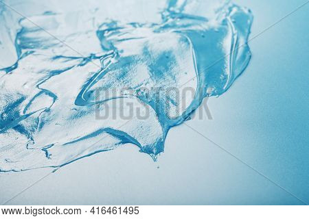 Gel With Hyaluronic Acid In The Form Of A Smear Of Glossy Texture On A Blue Background.