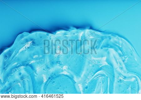 Gel With Hyaluronic Acid In The Form Of A Smear Of Glossy Texture On A Blue Background.
