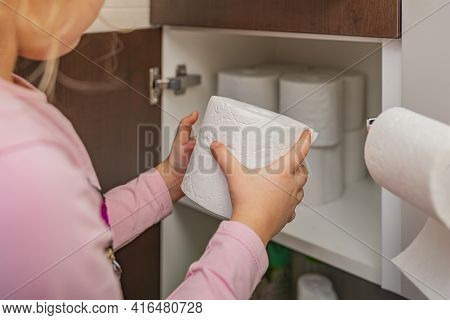 Toilet Paper, Roll Of Toilet Paper In Hand. Stocks Of Toilet Paper. Girl Puts Toilet Paper In The Ca