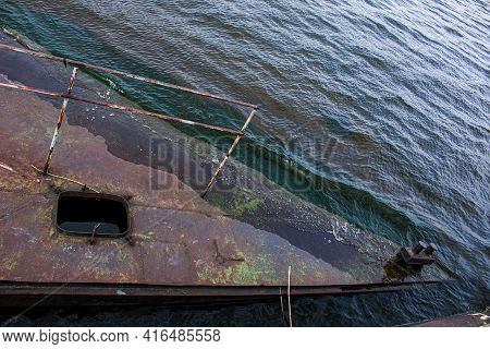 Old Rusty Sunken Pier In The Water On The Territory Of The River Port. Old Sunken Rusty Structure On
