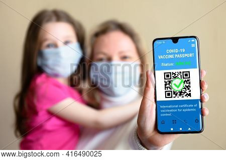 Health Digital Passport Of Covid-19 Vaccination In Mobile Phone, Happy Family Hold Smartphone With C