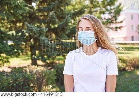 Young Woman Wearing Protective Mask Outdoors. Medicine Equipment. Pandemic Safety Concept. White T-s