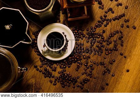 Coffee Stuff. Top View Of A White Cup With Black Coffee, Italian Coffee Maker Moka, A Mill And Grain