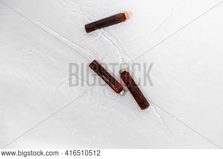 Amber Glass Bottles With Pipette. Transparent Hyaluronic Gel And Oil Skin Care Concept. Top Horizont
