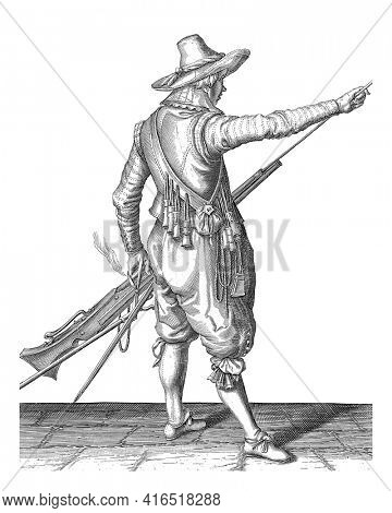 Soldier removing his ramrod from the holder under the barrel of his musket, vintage engraving.