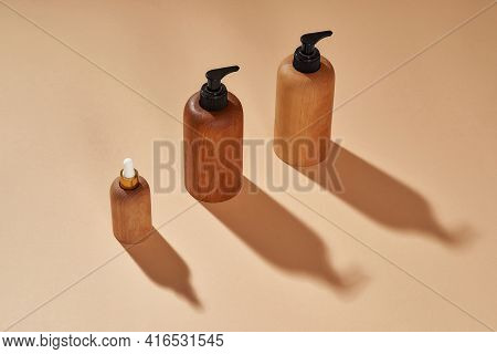 Closeup Of Wooden Bottles Of Different Sizes Isolated On Beige Background. Zero Waste And Eco Consci