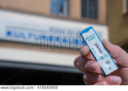 Berlin, Germany - April 11, 2021: Hand Hold Express Covid-19 Test In Front Of Cafe In Kulturbrauerei