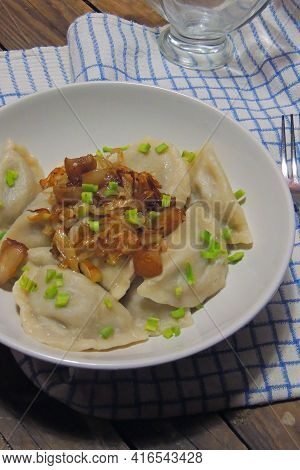 Fried Dumplings Stuffed With Cabbage And Meat Sprinkled With Bacon Greaves And Chopped Parsley On A