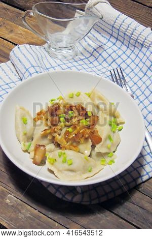 Fried Dumplings Stuffed With Cabbage And Meat Sprinkled With Bacon Greaves And Chopped Parsley On A