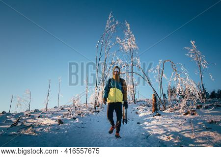 Teenager Snuggled Up In His Winter Jacket And Walks Through A Snowy Landscape In The Beskydy Mountai