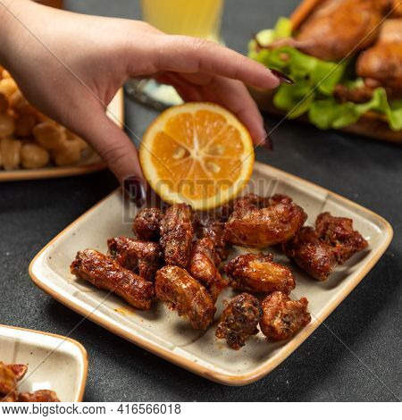 Squeezing Lemon On The Grilled Chicken Meat Dish