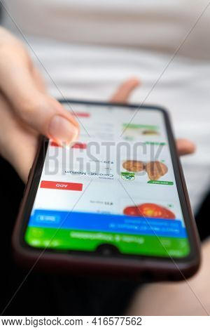 Mogilev, Belarus-march 23, 2021: Woman Orders Fresh Vegetables Through A Close-up Mobile Phone App.