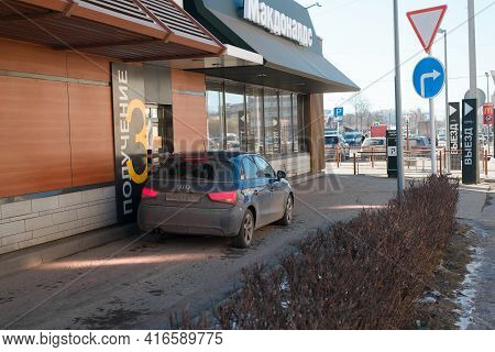 Service Point At Mcdonald's Restaurant For Drivers. The Man In The Car Picking Up Takeaway Food At M