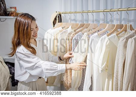 Portrait Of Happy Female Asian Entrepreneur Working In Her Modern Store With Womenswear Clothes, You