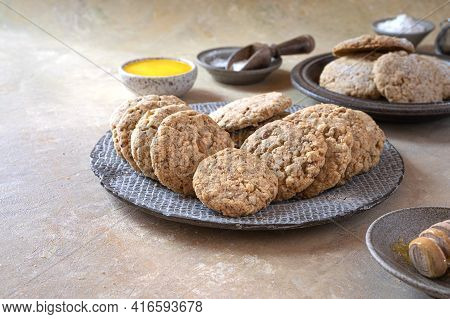 Shortbread Cookies With Almonds-polvorones, A Traditional Spanish Sweet Close-up. A Saucer Of Honey 