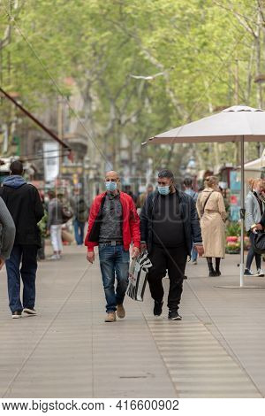 Barcelona, Catalonia: 2021 April 6: People Walk In The Ramblas In The City Of Barcelona In Time Of C