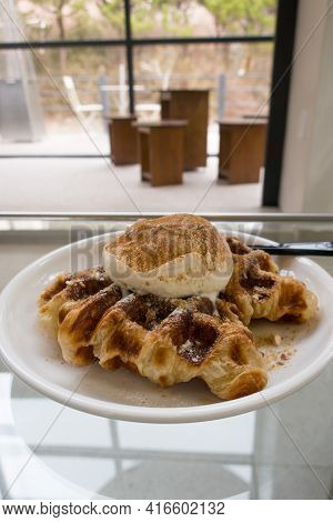 A Baked Croissant Dough In Waffle Iron With A Scoop Of Vanilla Ice Cream.