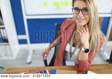 Young Beautiful Woman Sitting At Table In Office