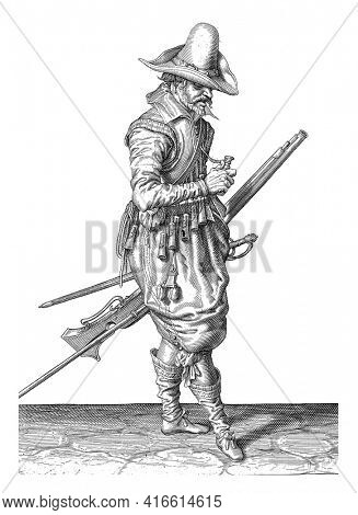 A soldier, full-length, to the right, who with his left hand is holding a musket (a certain type of firearm) by his left thigh, pointing the barrel diagonally upwards, vintage engraving.