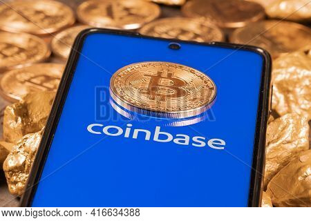 Coinbase Crypto Exchange Logo On Screen With Bitcoin Coins. Ljubljana, Slovenia - April 12 2021