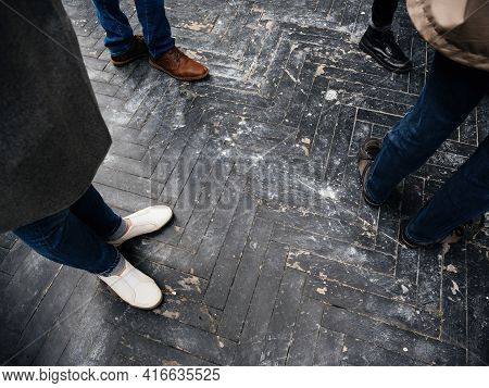 View From Above At The Human Feets Walking On Old Wooden Black Parquet Surface