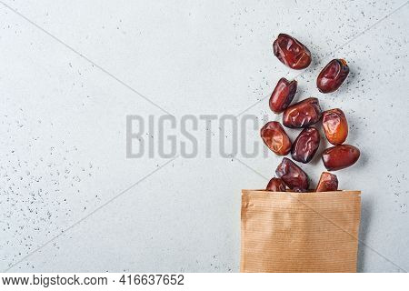 Dried Sliced Date Fruit In Paper Bag On White Background With Copy Space. Snack Vegan Sugarfree Food