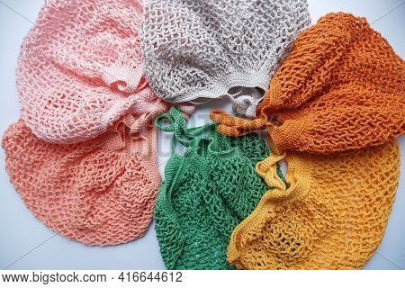 Colorful String Bags, Shopping Bag On A White Background, Photo From Above. Colorful String Bags, Co