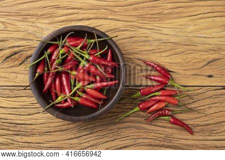 Red Malagueta Chili Peppers On A Bowl Over Wooden Table.