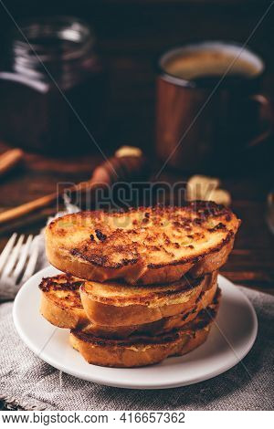 French Toasts On White Plate Over Wooden Surface