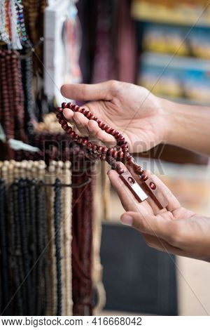 Asian Muslim Man Hand Shopping For Clothes At Store