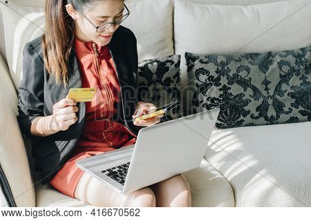 Portrait Of Business Woman Holding Credit Card During Using Laptop For Online Shopping. Online Shopp