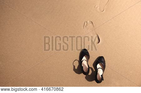 Work Life Balance Concept. Business Woman Take Off Her Working Shoes And Leave It On The Sand Beach 