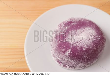 Closeup Of Japanese Purple Sweet Potato Daifuku Or Red Bean Paste Filling Rice Cake On White Plate